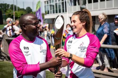 A man and a woman holding a trophy together