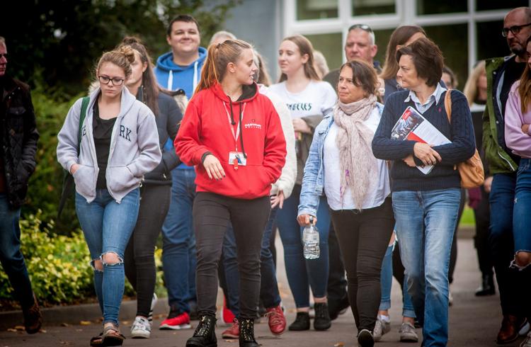 Student Ambassador Chatting To Students While Walking